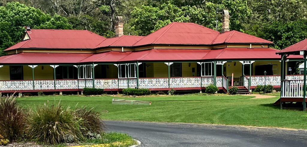 O'Reillys Canungra Valley vineyard - The old Queenslander homestead with red roof, wide verandahs and wrought iron lattice work