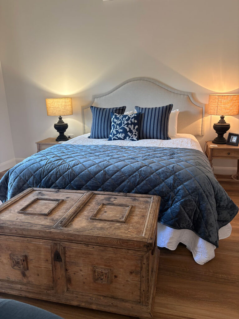 King bed with a navy quilt in The Bode, a romantic Scenic Rim cottage for two