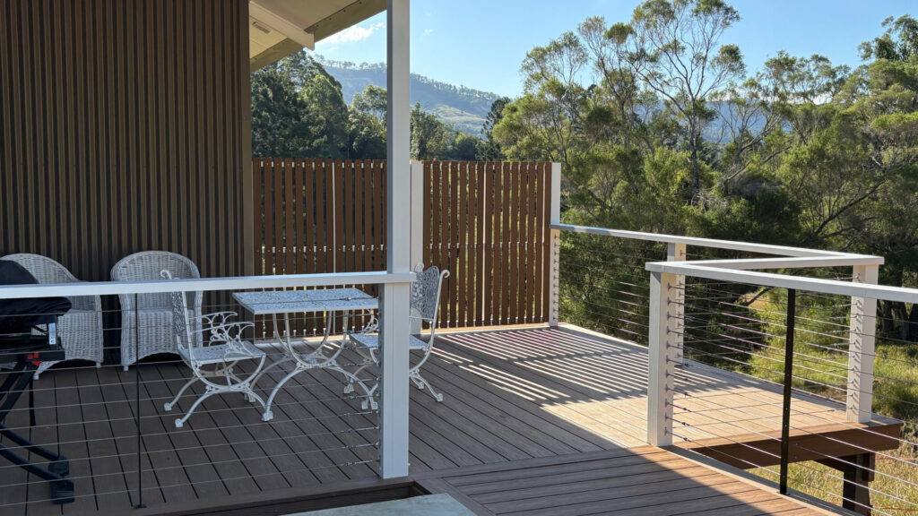 Private deck at The Bode with outdoor dining setting and views to the hills, Scenic Rim